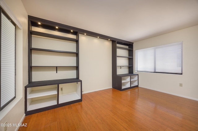 9846 E 2nd St, Tucson, AZ 85748 - unfurnished bedroom featuring wood finished floors and baseboards