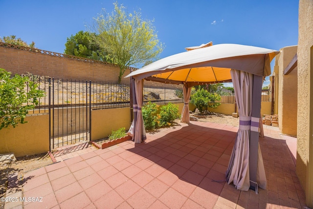 9846 E 2nd St, Tucson, AZ 85748 - view of patio / terrace with a fenced backyard, a gazebo, and a gate