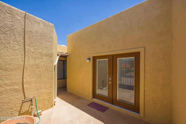 9846 E 2nd St, Tucson, AZ 85748 - property entrance with french doors, a patio area, and stucco siding