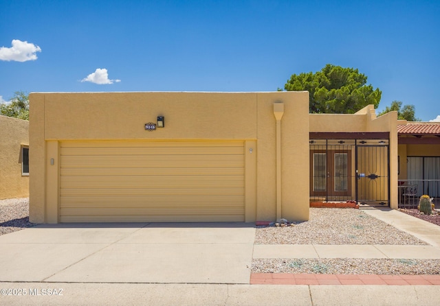 9846 E 2nd St, Tucson, AZ 85748 - view of front facade featuring stucco siding, an attached garage, and concrete driveway
