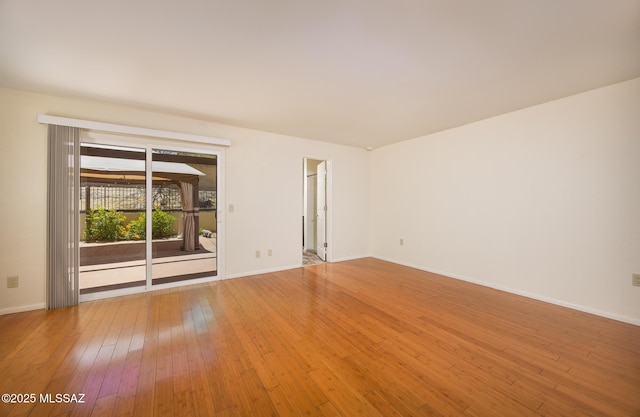 9846 E 2nd St, Tucson, AZ 85748 - spare room with hardwood / wood-style flooring and baseboards