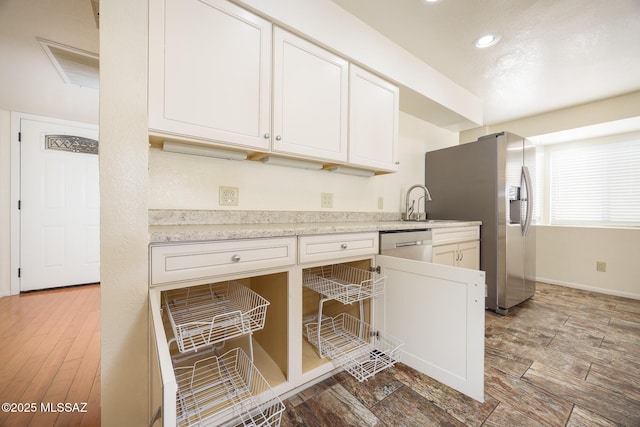 9846 E 2nd St, Tucson, AZ 85748 - kitchen featuring stainless steel appliances, light countertops, white cabinetry, recessed lighting, and a sink