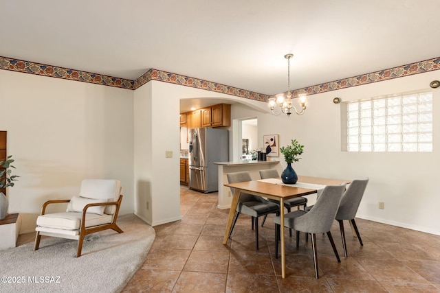 2826 E Kleindale Rd, Tucson, AZ 85716 - dining room with arched walkways, a chandelier, light tile patterned floors, and baseboards