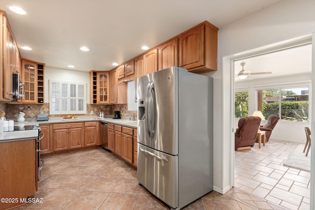 2826 E Kleindale Rd, Tucson, AZ 85716 - kitchen featuring stainless steel appliances, backsplash, recessed lighting, glass insert cabinets, and open shelves