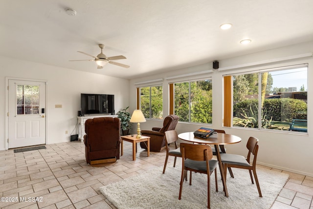 2826 E Kleindale Rd, Tucson, AZ 85716 - dining space featuring healthy amount of natural light, ceiling fan, baseboards, and stone tile floors
