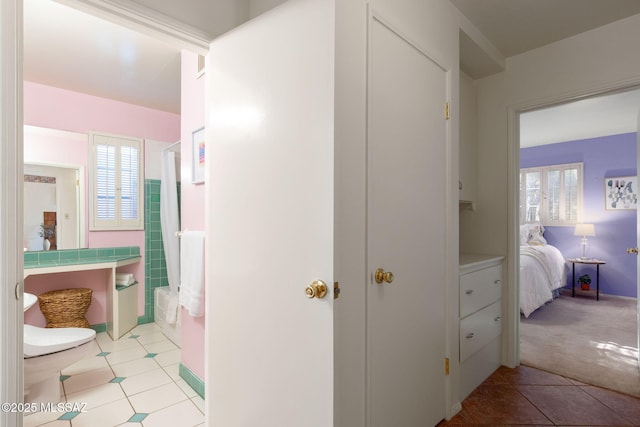 2826 E Kleindale Rd, Tucson, AZ 85716 - hallway featuring healthy amount of natural light, light tile patterned floors, light colored carpet, and baseboards