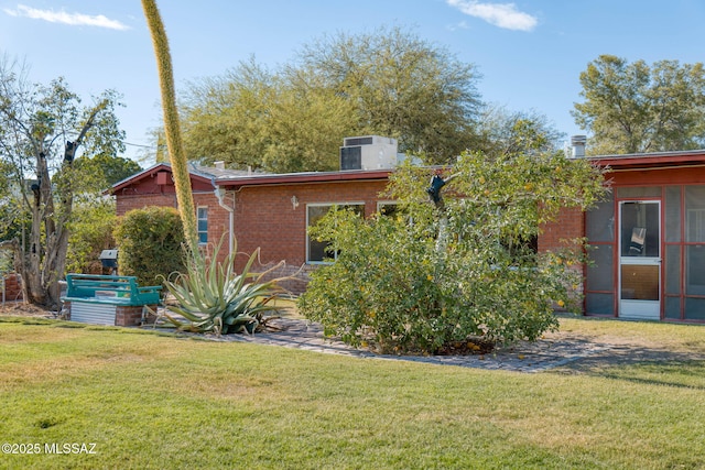 2826 E Kleindale Rd, Tucson, AZ 85716 - view of front of house with brick siding, a front lawn, and central air condition unit