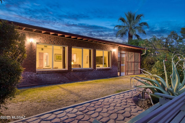 2826 E Kleindale Rd, Tucson, AZ 85716 - back of house at dusk with brick siding