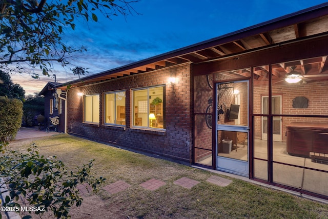 2826 E Kleindale Rd, Tucson, AZ 85716 - rear view of property featuring a hot tub, brick siding, a patio, ceiling fan, and a yard