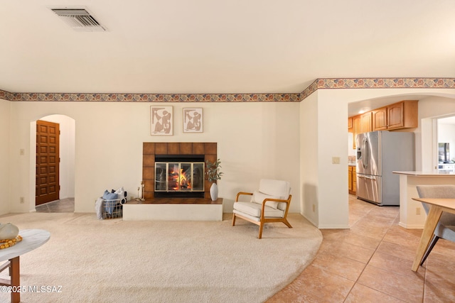 2826 E Kleindale Rd, Tucson, AZ 85716 - living area featuring arched walkways, a fireplace, and light tile patterned floors