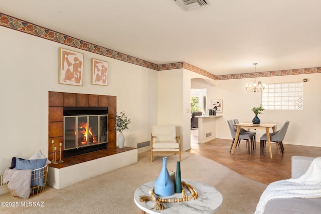2826 E Kleindale Rd, Tucson, AZ 85716 - living room with a chandelier, arched walkways, and a tiled fireplace