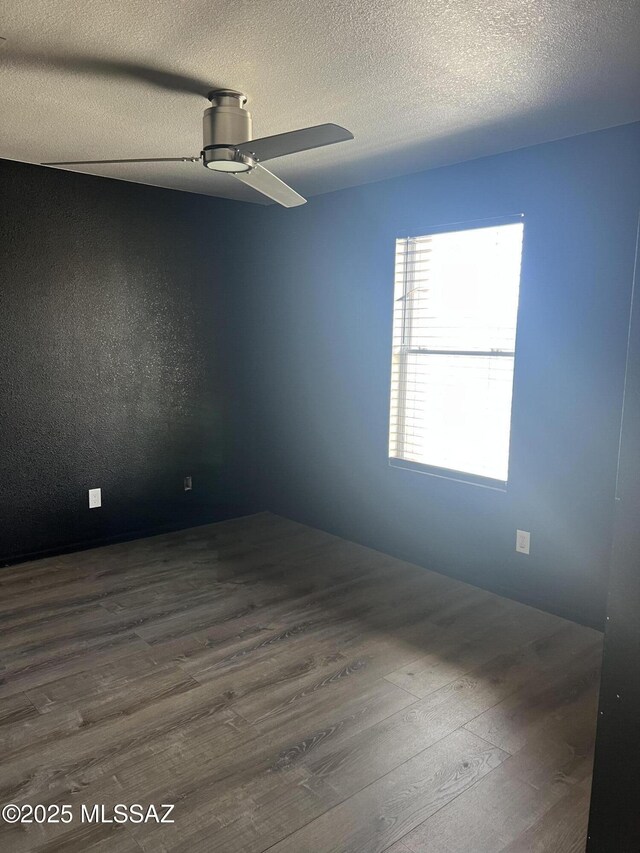 1558 E Los Cabos Pl, Tucson, AZ 85706 - empty room with dark wood-style flooring, ceiling fan, and a textured ceiling