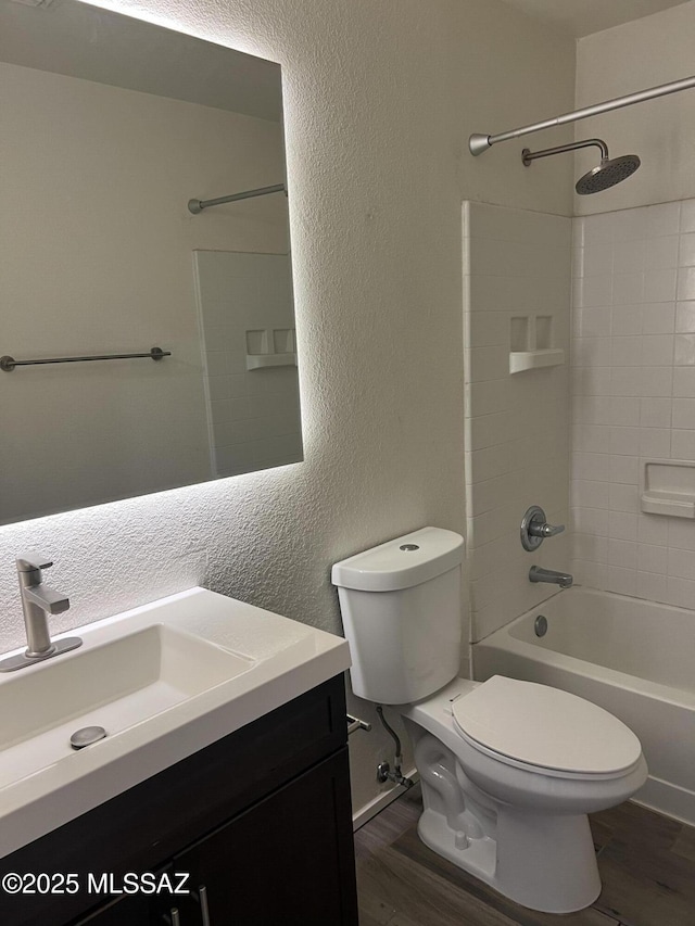 1558 E Los Cabos Pl, Tucson, AZ 85706 - bathroom with wood finished floors, toilet, a textured wall, vanity, and shower / bathtub combination