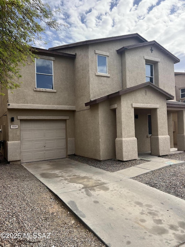 1558 E Los Cabos Pl, Tucson, AZ 85706 - view of front of house featuring stucco siding, a garage, and concrete driveway