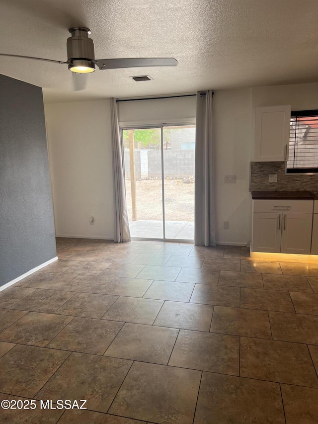 1558 E Los Cabos Pl, Tucson, AZ 85706 - spare room featuring baseboards, a textured ceiling, and ceiling fan