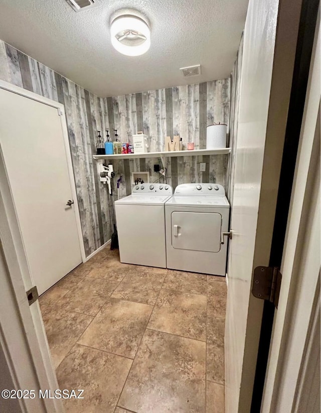 1558 E Los Cabos Pl, Tucson, AZ 85706 - washroom featuring separate washer and dryer, wallpapered walls, and a textured ceiling