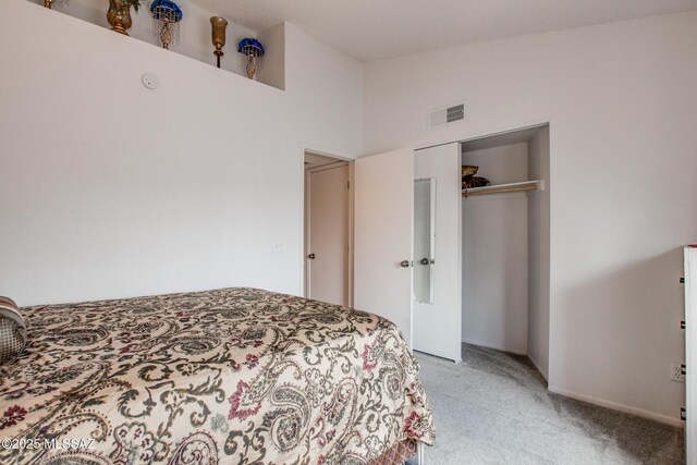 10095 E Autumnwind Pl, Tucson, AZ 85730 - bedroom with light colored carpet, a closet, and lofted ceiling