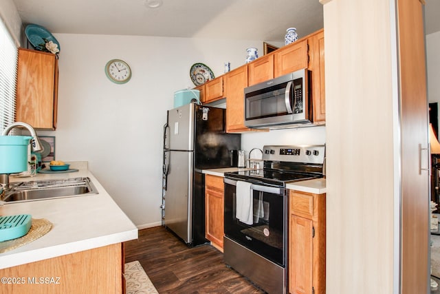 10095 E Autumnwind Pl, Tucson, AZ 85730 - kitchen featuring appliances with stainless steel finishes, a sink, light countertops, dark wood finished floors, and baseboards