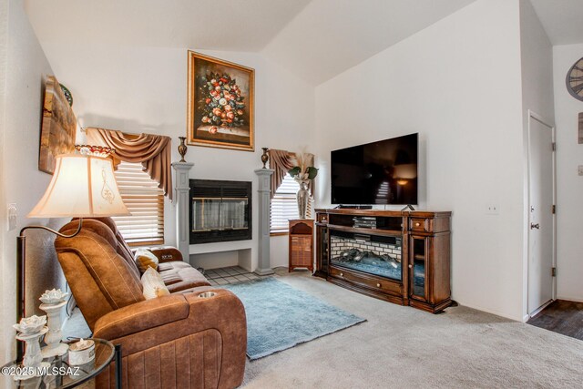 10095 E Autumnwind Pl, Tucson, AZ 85730 - carpeted living area with a glass covered fireplace and vaulted ceiling