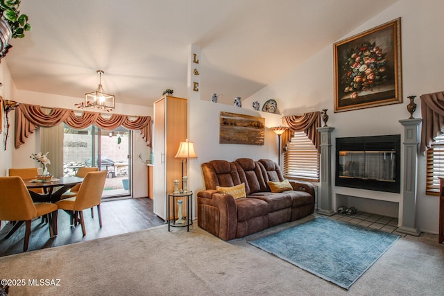 10095 E Autumnwind Pl, Tucson, AZ 85730 - carpeted living area featuring a chandelier, vaulted ceiling, and a glass covered fireplace