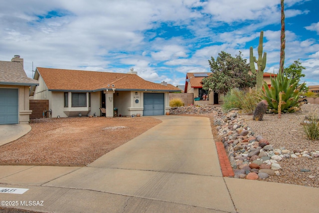 10095 E Autumnwind Pl, Tucson, AZ 85730 - view of front of home featuring concrete driveway, a garage, stucco siding, and fence