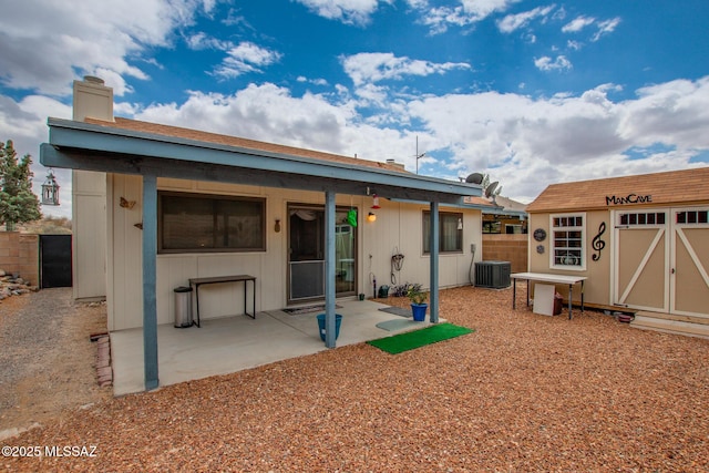 10095 E Autumnwind Pl, Tucson, AZ 85730 - rear view of property featuring a patio area, central AC, a storage shed, an outdoor structure, and fence