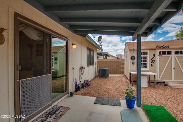 10095 E Autumnwind Pl, Tucson, AZ 85730 - view of patio featuring cooling unit, fence, an outbuilding, and a storage unit