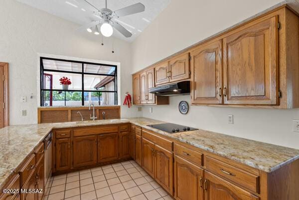 1861 N Camino Claveles, Tucson, AZ 85745 - kitchen with under cabinet range hood, light tile patterned floors, light stone countertops, a sink, and a ceiling fan