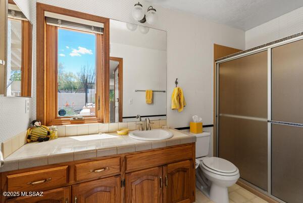 1861 N Camino Claveles, Tucson, AZ 85745 - bathroom with toilet, vanity, and a shower with door