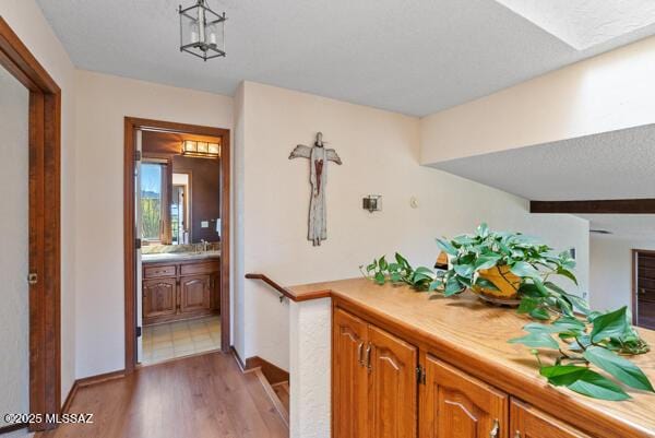 1861 N Camino Claveles, Tucson, AZ 85745 - corridor featuring light wood-style floors and baseboards