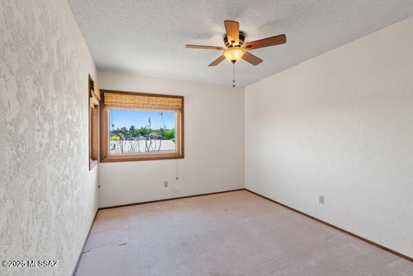 1861 N Camino Claveles, Tucson, AZ 85745 - unfurnished room with a ceiling fan, carpet flooring, and a textured ceiling