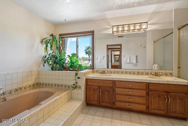 1861 N Camino Claveles, Tucson, AZ 85745 - bathroom with a garden tub, double vanity, and an enclosed shower