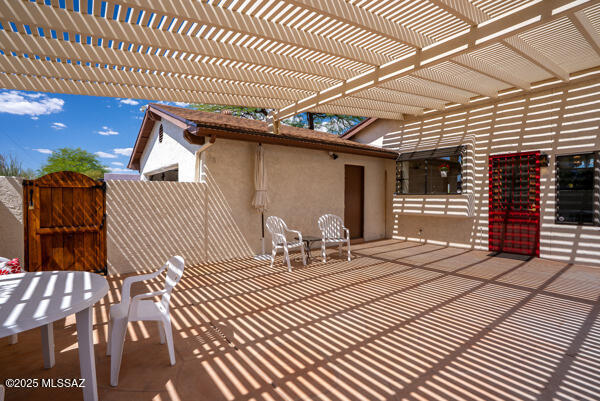 1861 N Camino Claveles, Tucson, AZ 85745 - view of patio featuring a gate, a pergola, and fence
