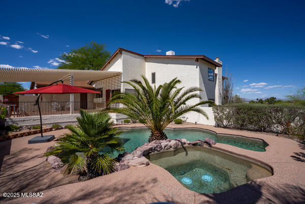 1861 N Camino Claveles, Tucson, AZ 85745 - view of swimming pool featuring a patio, a pool with connected hot tub, and fence