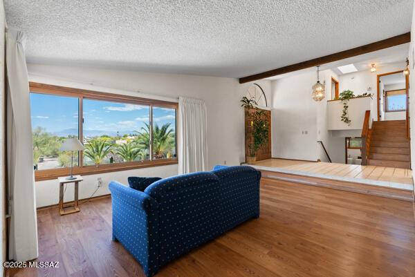 1861 N Camino Claveles, Tucson, AZ 85745 - living area with a textured ceiling, wood finished floors, stairs, and a skylight