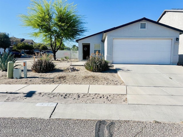 3756 W Exton Ln, Tucson, AZ 85746 - ranch-style home featuring a garage, driveway, and stucco siding
