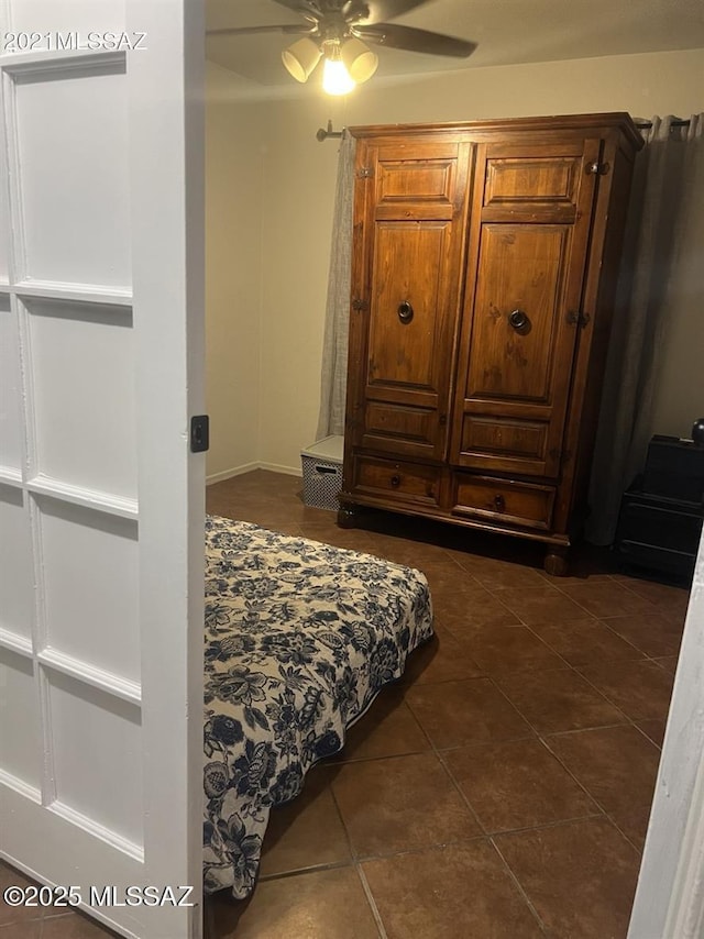 3756 W Exton Ln, Tucson, AZ 85746 - bedroom with dark tile patterned floors and a ceiling fan