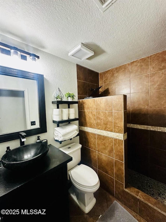 3756 W Exton Ln, Tucson, AZ 85746 - full bath featuring vanity, a walk in shower, a textured ceiling, tile patterned flooring, and a textured wall