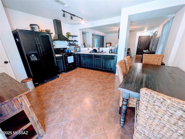 3756 W Exton Ln, Tucson, AZ 85746 - kitchen with black appliances, range hood, light tile patterned floors, light countertops, and track lighting