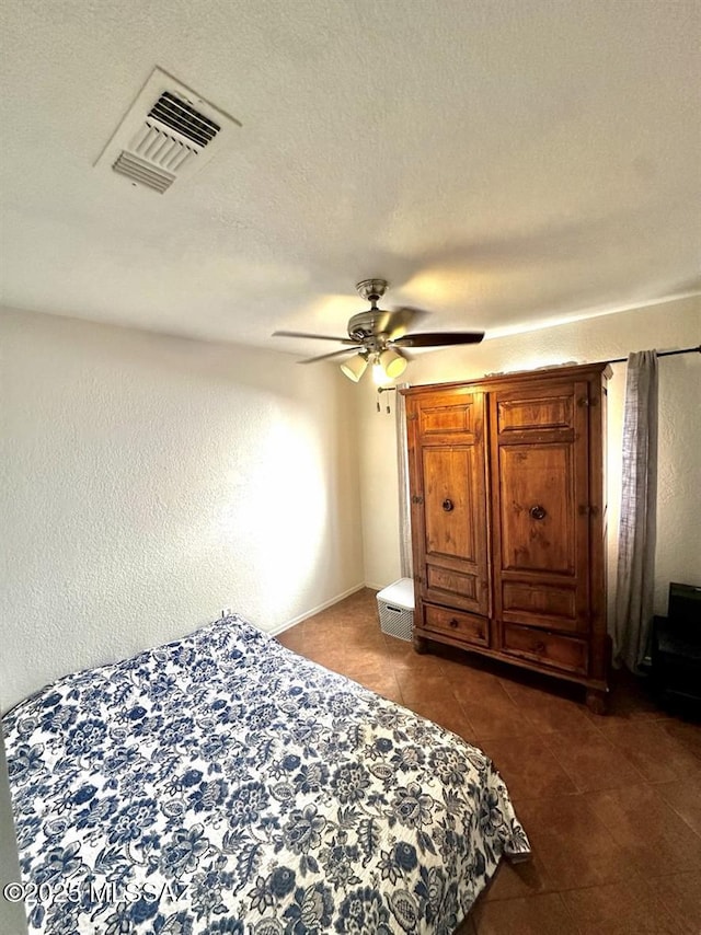 3756 W Exton Ln, Tucson, AZ 85746 - bedroom with dark tile patterned flooring, ceiling fan, and a textured ceiling