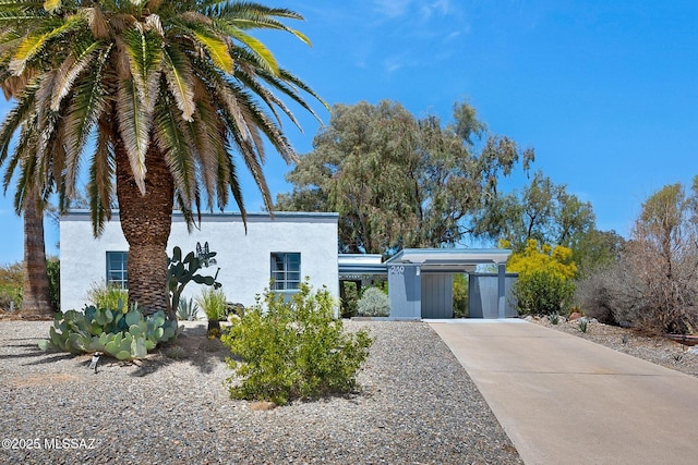 210 S Abrego Dr, Green Valley, AZ 85614 - view of front of home with driveway, stucco siding, and an attached carport
