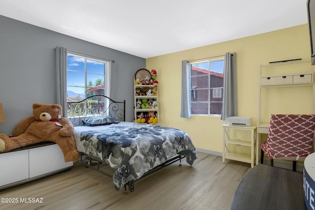 210 S Abrego Dr, Green Valley, AZ 85614 - bedroom with wood finished floors, multiple windows, and baseboards