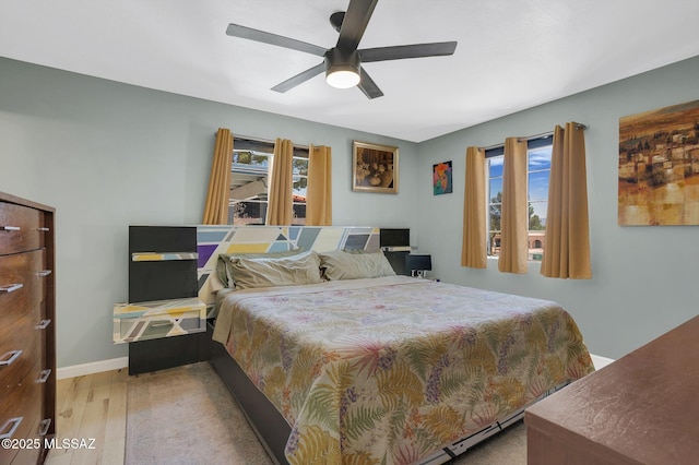 210 S Abrego Dr, Green Valley, AZ 85614 - bedroom with multiple windows, wood finished floors, and a ceiling fan