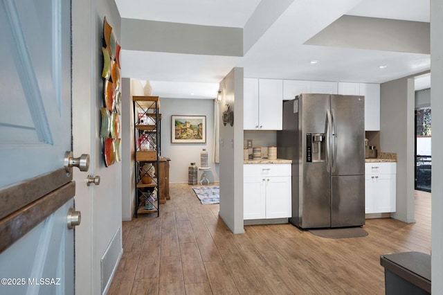 210 S Abrego Dr, Green Valley, AZ 85614 - kitchen with stainless steel fridge with ice dispenser, light wood-style flooring, light stone counters, and recessed lighting