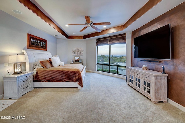 bedroom featuring light carpet, baseboards, a tray ceiling, ceiling fan, and recessed lighting