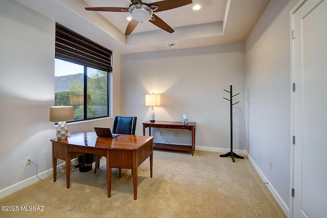office space with ceiling fan, light carpet, baseboards, a tray ceiling, and recessed lighting