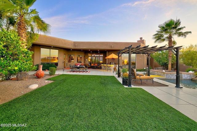 back of house featuring a lawn, a pergola, a patio, and a pool with connected hot tub