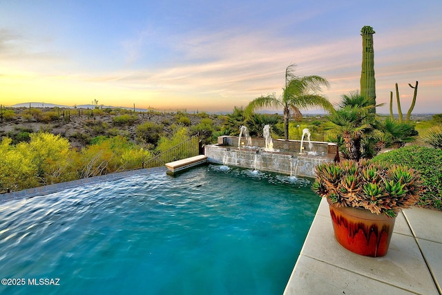 view of pool at dusk