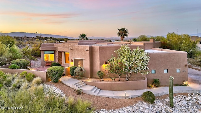 pueblo-style house with stucco siding