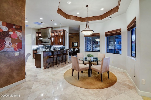 dining room featuring baseboards, recessed lighting, and light tile patterned floors
